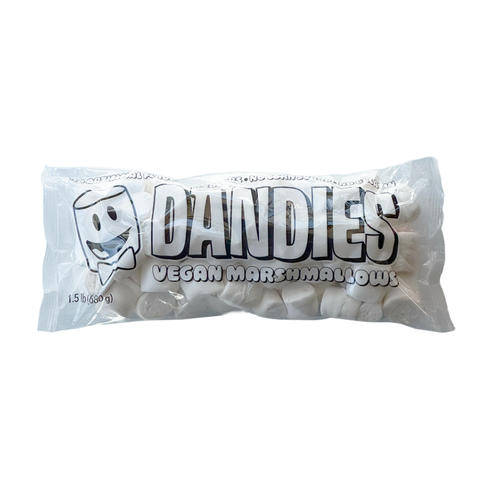 A package of Dandies Classic Vegan Marshmallows, showing the white marshmallows visible through a clear plastic bag with bold black and white branding.