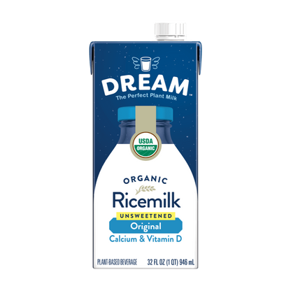 A 32 fl oz carton of Dream Organic Rice milk, Unsweetened, Calcium & Vitamin D. The carton features a dark blue top half with white starry speckles, a white lower half, and a blue cap with a gold USDA Organic seal.