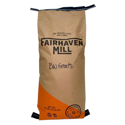 A 25 lb paper bag of Fairhaven Mill Buckwheat Groats, featuring a brown kraft paper body with a bright orange section at the bottom and black printed text and logo.