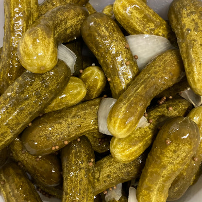 Wet fermented pickles with coriander seeds and slices of onion