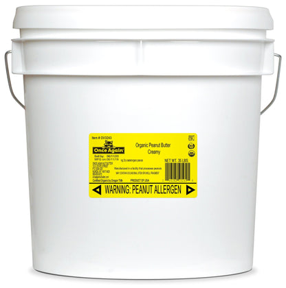 A 35 lb tub of Once Again Organic Creamy Peanut Butter, Unsalted. It has a yellow label with the logo, allergen information, and certifications for organic and kosher.