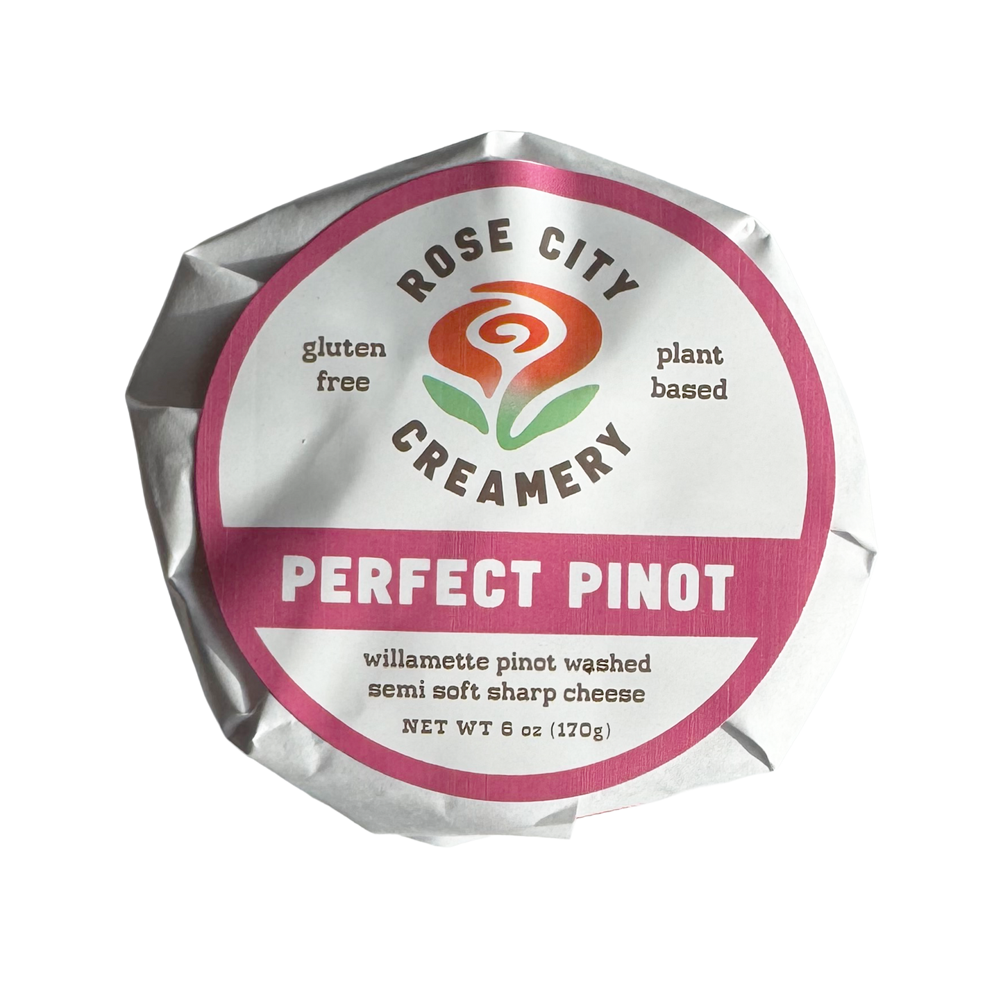 A wrapped wheel of Rose City Creamery Perfect Pinot cheese. The label is white with fuchsia accents and an abstract swirly rose logo